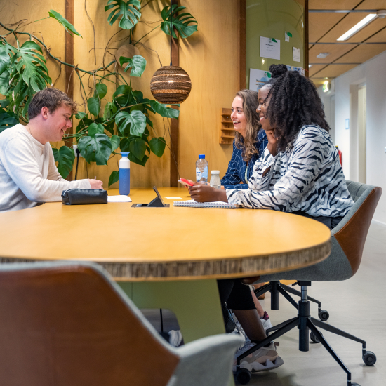 3 colleagues around a table at The Hague Humanity Hub