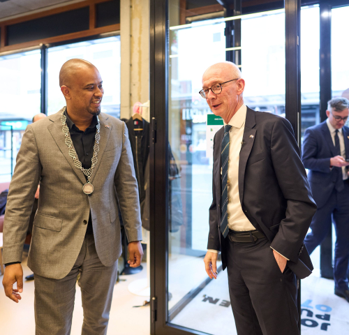 Two men talking in a modern space.