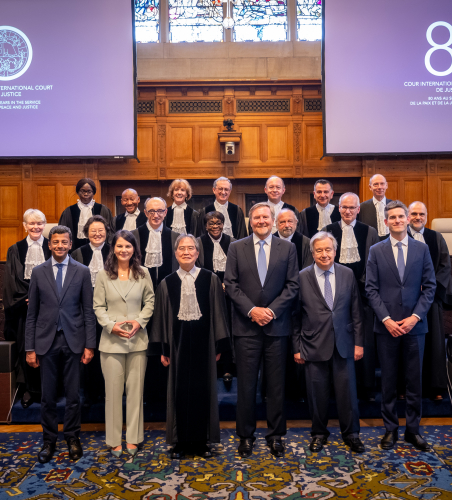 Group of people in robes posing in the courtroom.