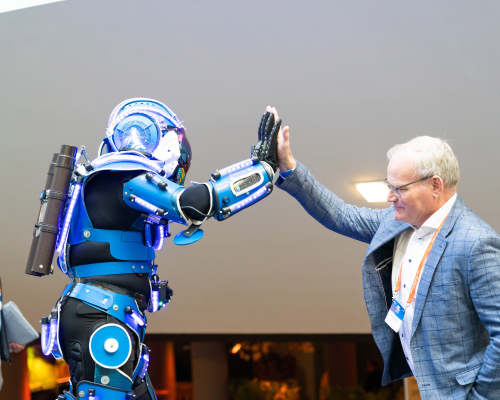 robot and man in suit doing a high five