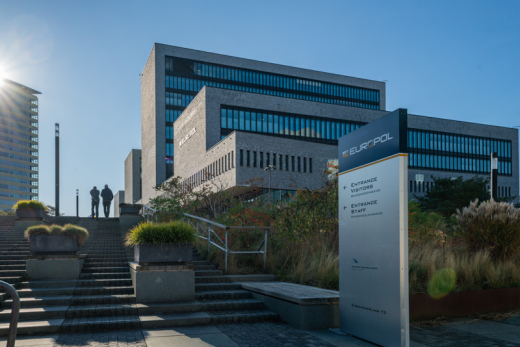 Two people walking up the steps at the Europol office